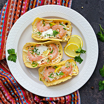 three grilled shrimp tacos on a plate